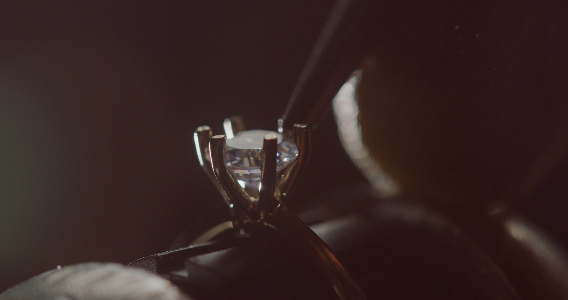 Jeweler Setting Precious Gemstone in Ring with Bright Illumination